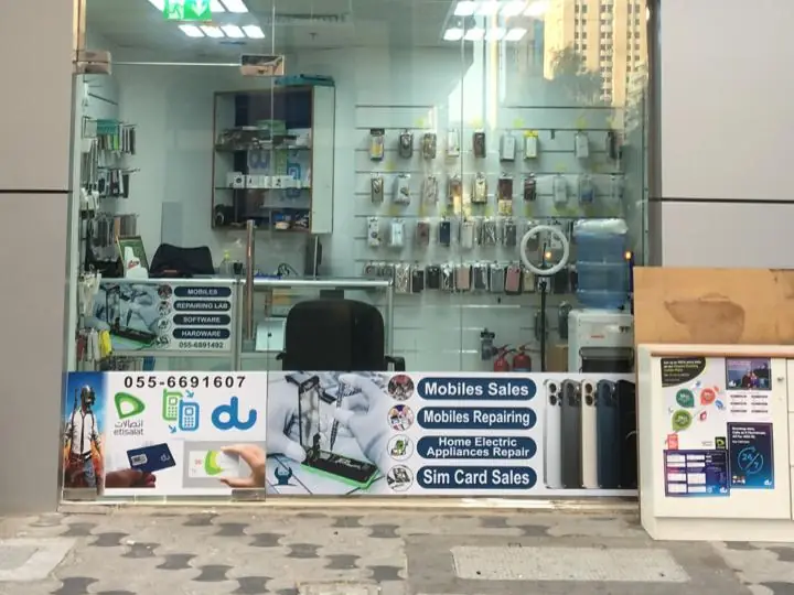 The shop window, lettered: Mobiles Sales, Mobiles Repairing, Home Electric Appliances Repair, Sim Card Sales